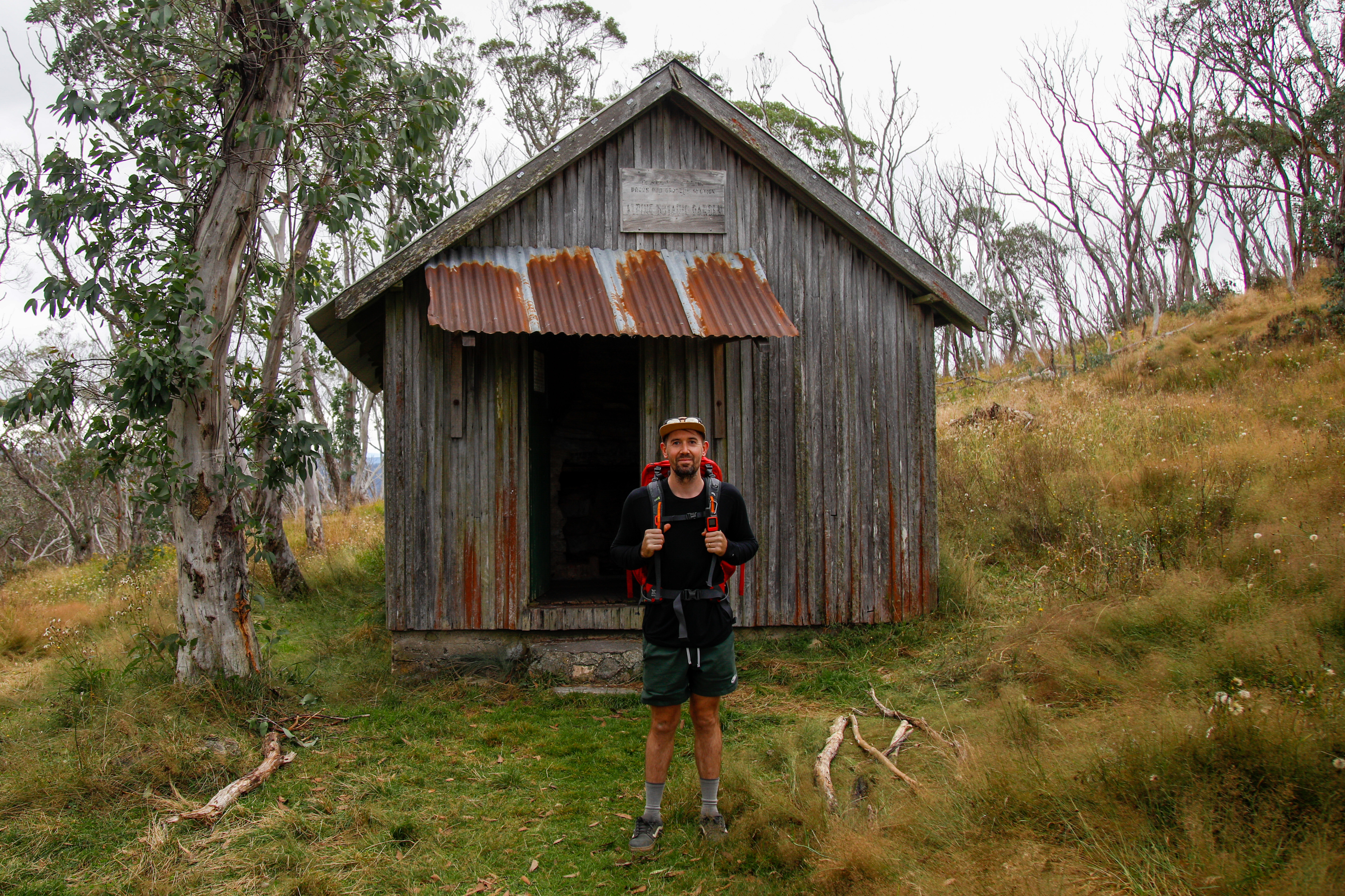 Hiker standing outside Pryors hut
